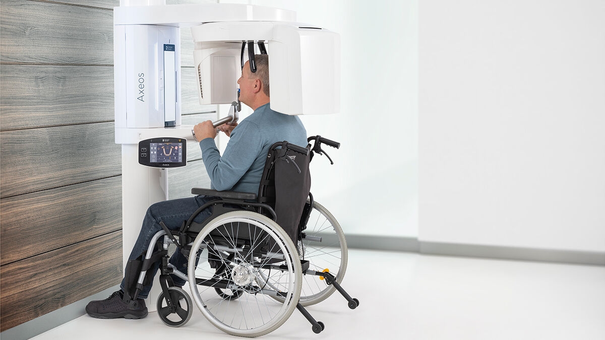 Man in wheelchair having the occlusal bite in his mouth 