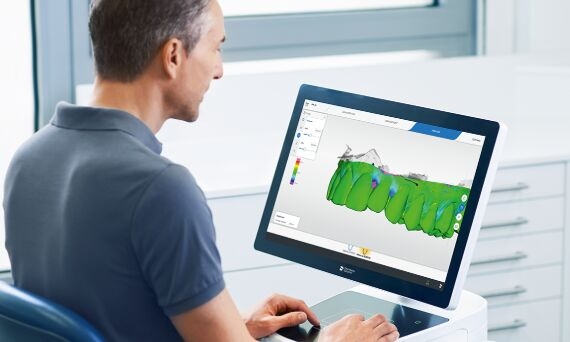 Male dentist working with OraCheck patient monitoring software