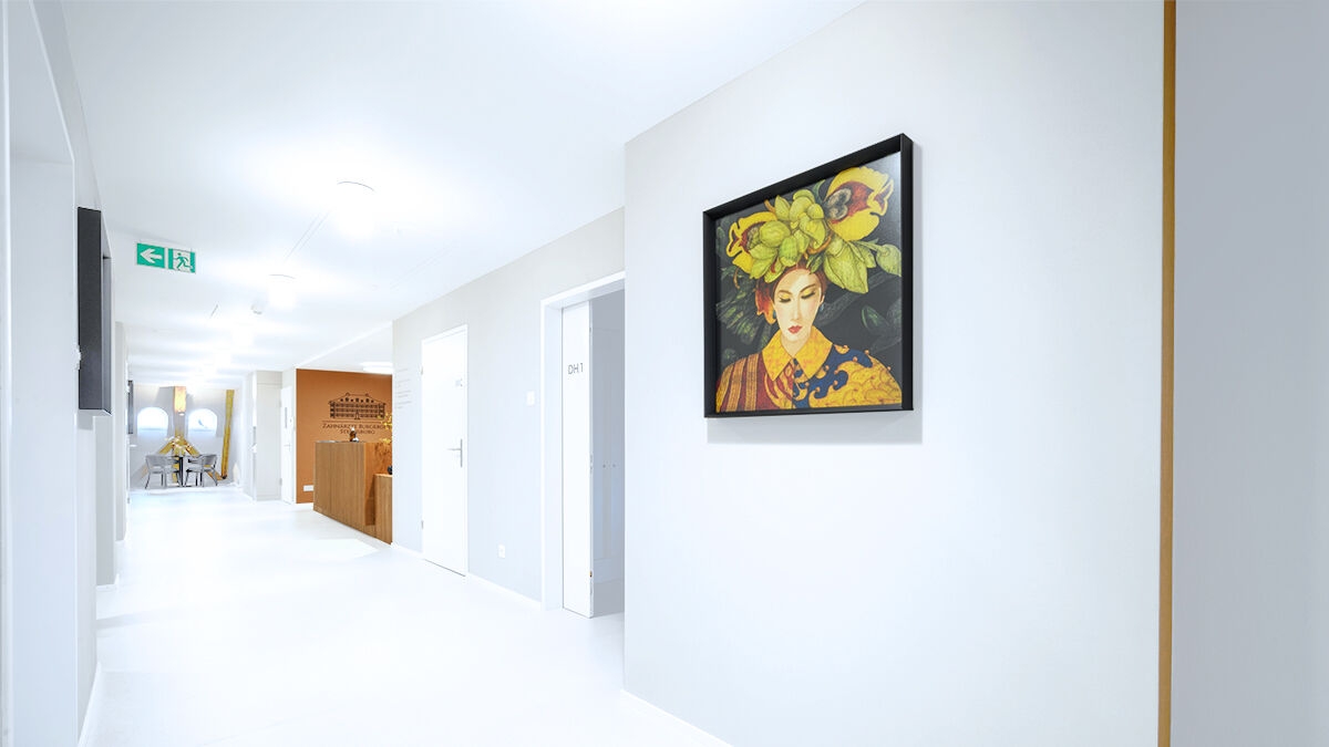 Hallway of a dental office with clear interior design, colorful accents and painting.