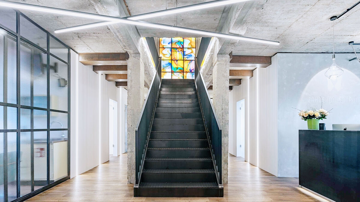 Staircase leading to a stained glass window.
